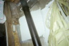 Looking up  blackstove pipe and at strong plastic window at top of this photo 